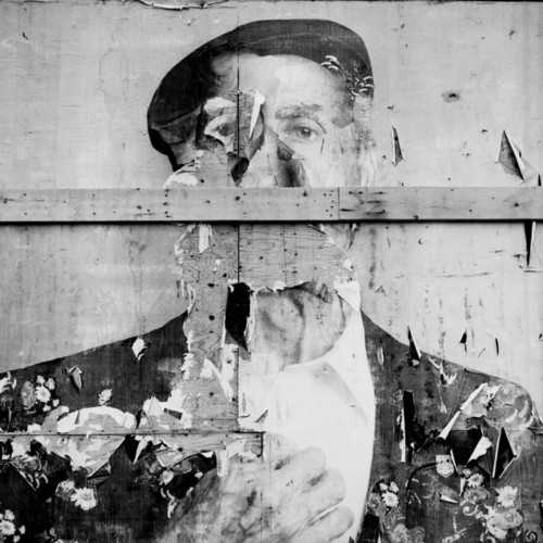 A decaying mural of a man